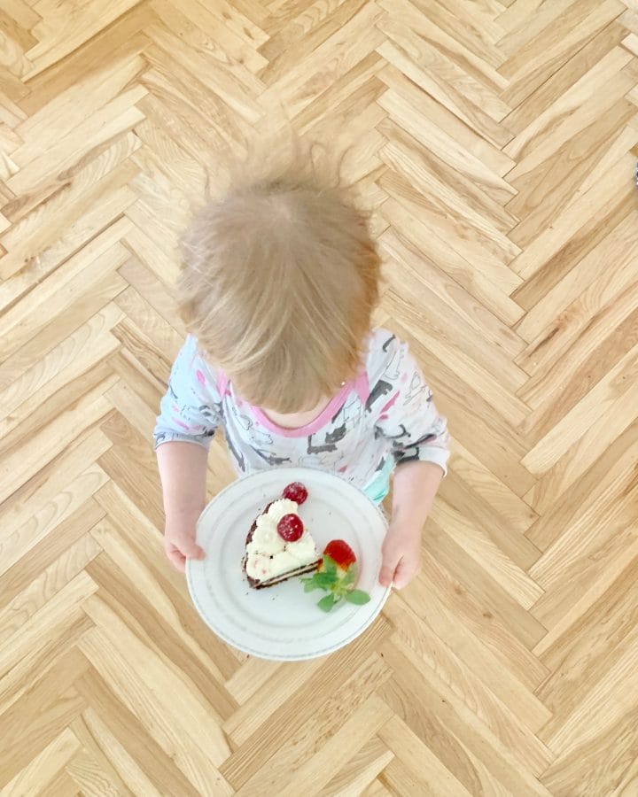 Picture of a little girl with a slice of low carb birthday cake 
