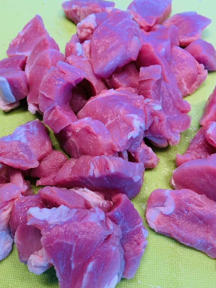 Picture of raw tenderized meat on a green surface