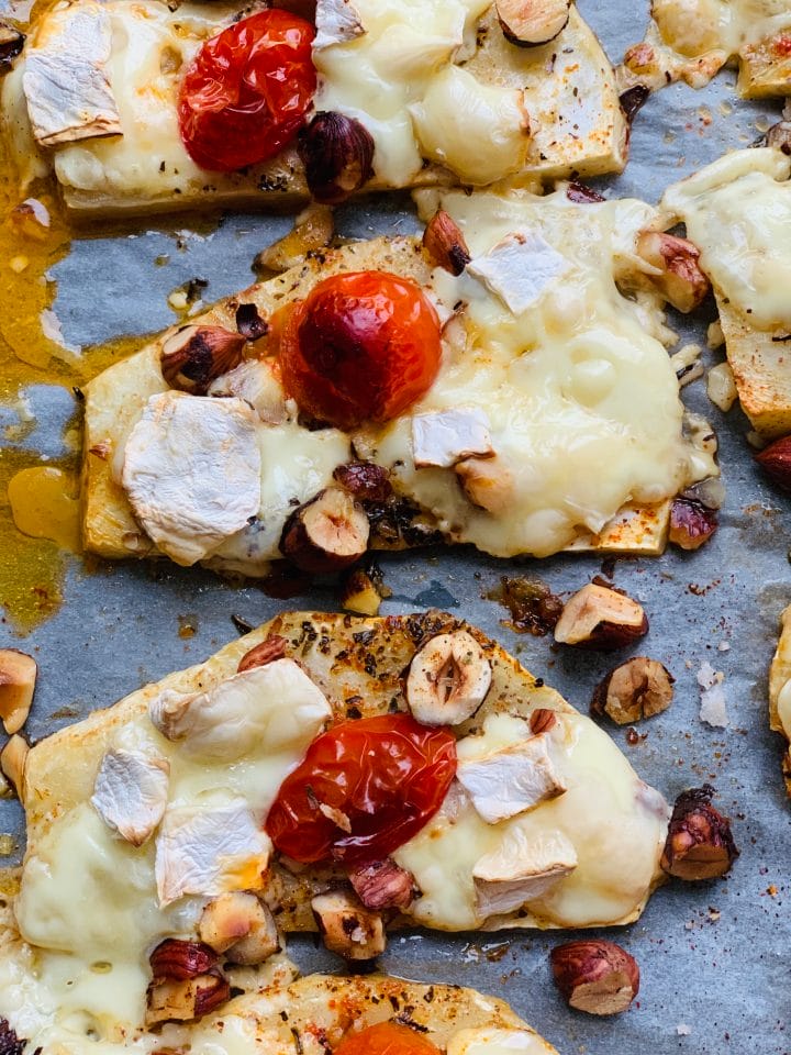 Picture of roasted celery steaks with cherries, cheese and hazelnuts on a parchment paper