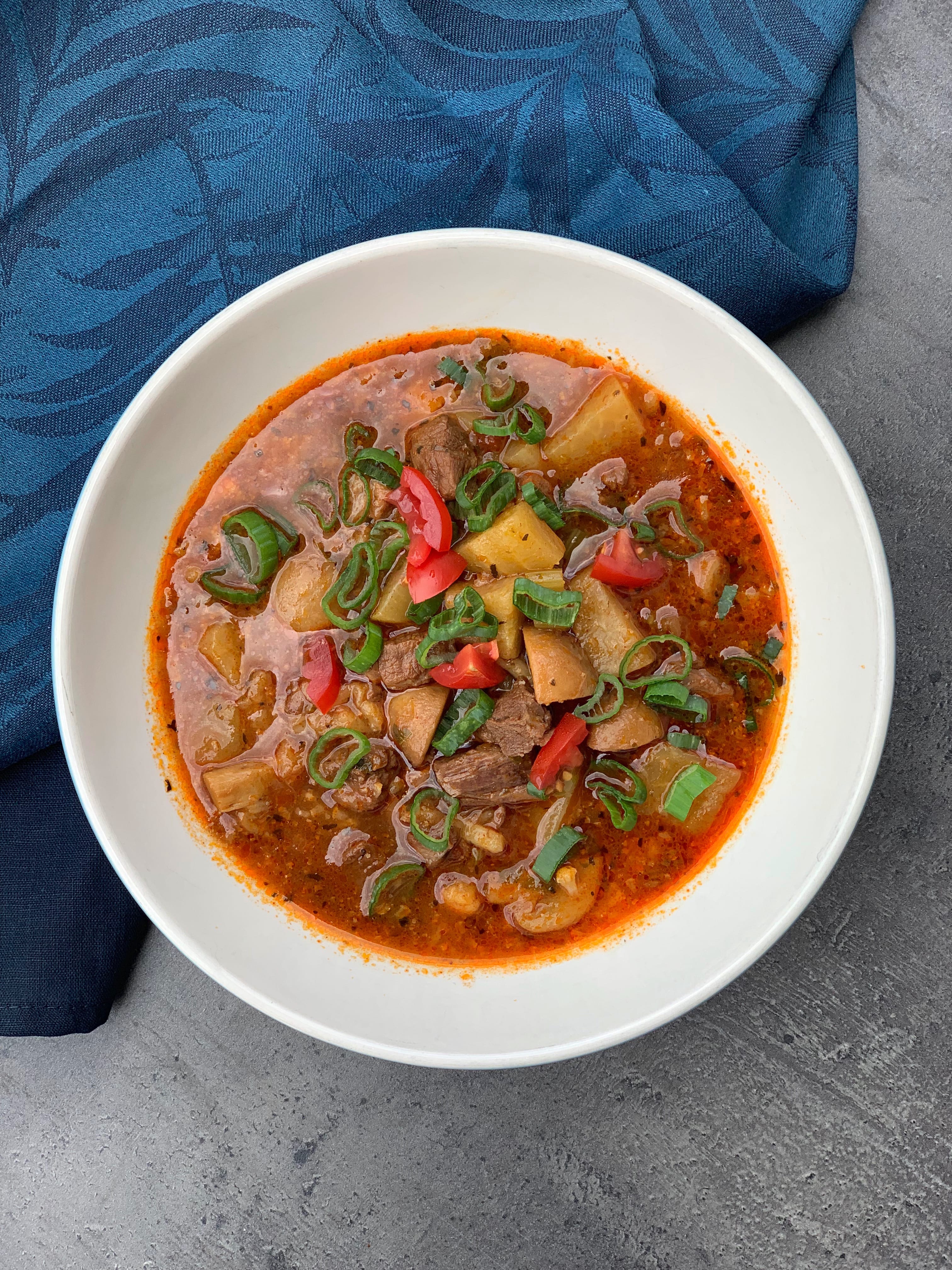 Picture of a beef vegetable soup in a bowl on the table