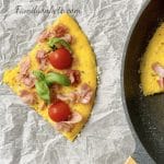 Picture of a slice of omelette pizza on a parchment paper