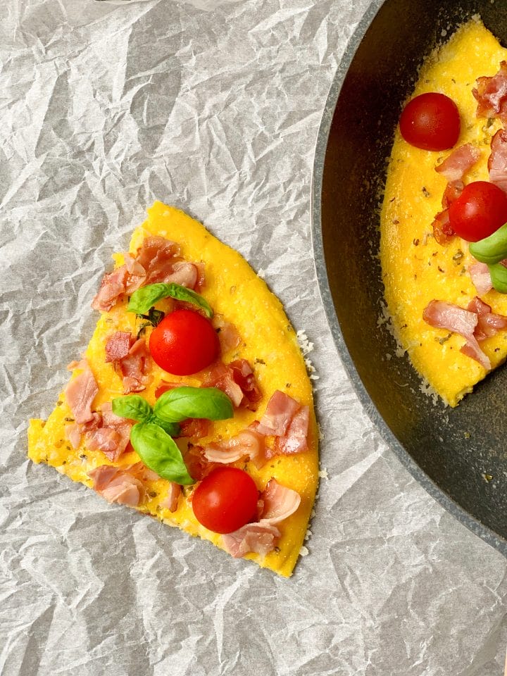 Picture of a omelette pizza with cherry tomato and basil