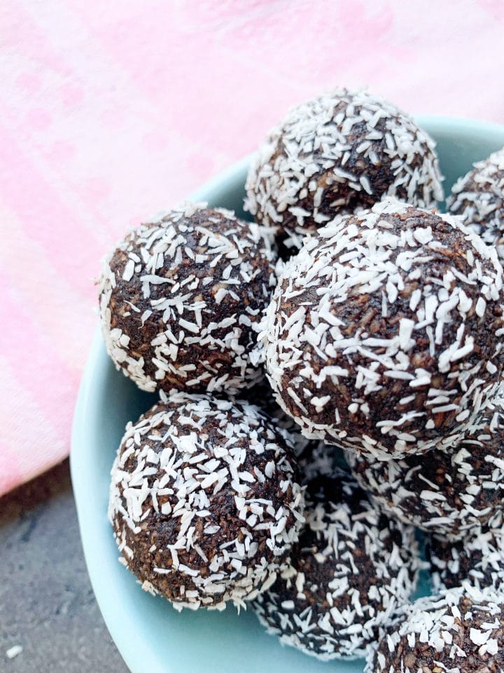 Picture of a bowl full of keto vegan energy balls with coconut and nuts