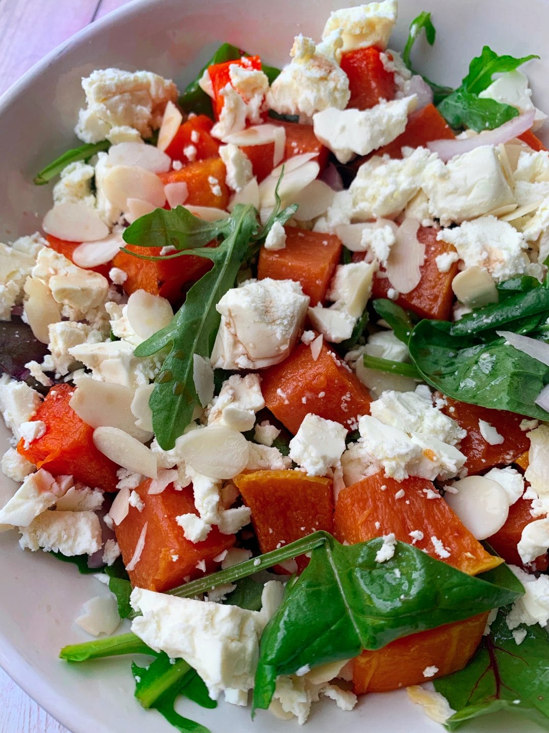 Leafy green salad of arugula, baby spinach with roast pumpkin and feta cheese