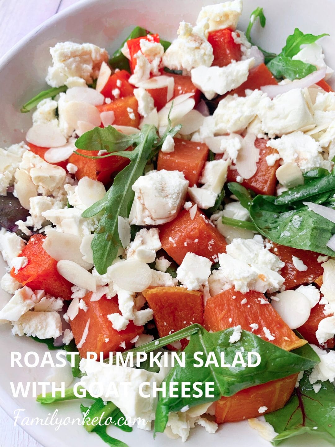Picture of bowl of leafy green salad with roasted pumpkin and feta cheese
