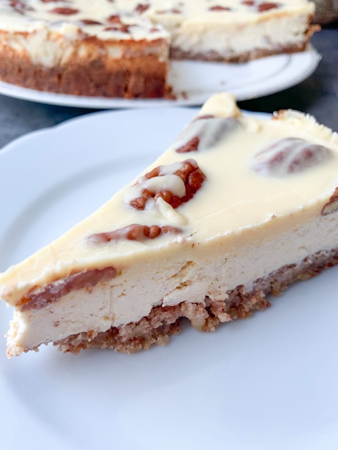 Picture of a slice of low carb pecan pie cheesecake with keto caramel topping with erythritol 