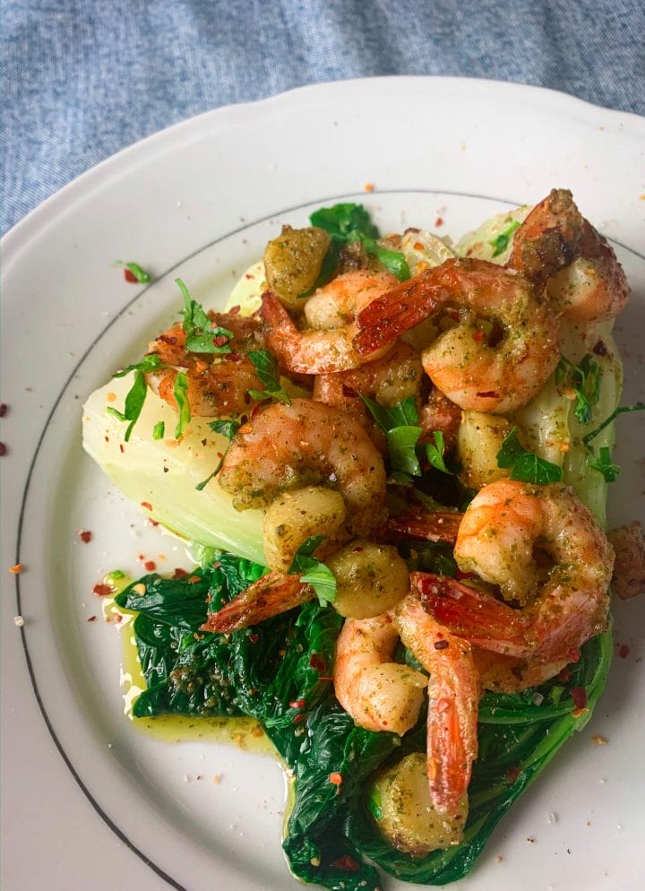 Picture of a plate full of bok choy with scallops and prawns seasoned with garlic and chilli