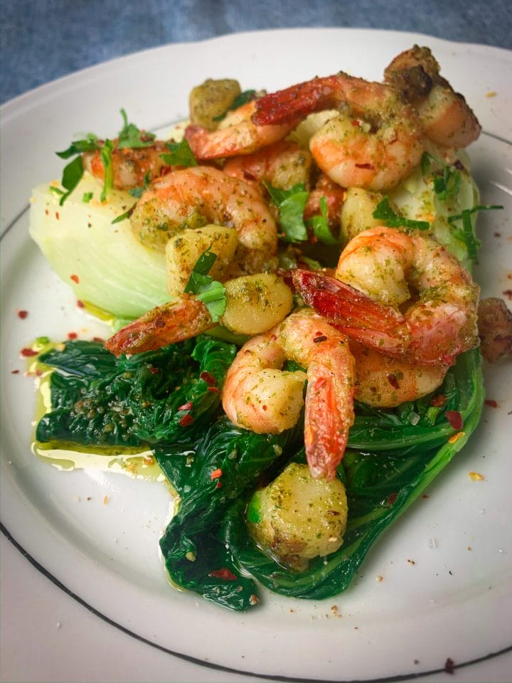 Picture of a plate full of bok choy with sauteed shrimps and scallops and chilli