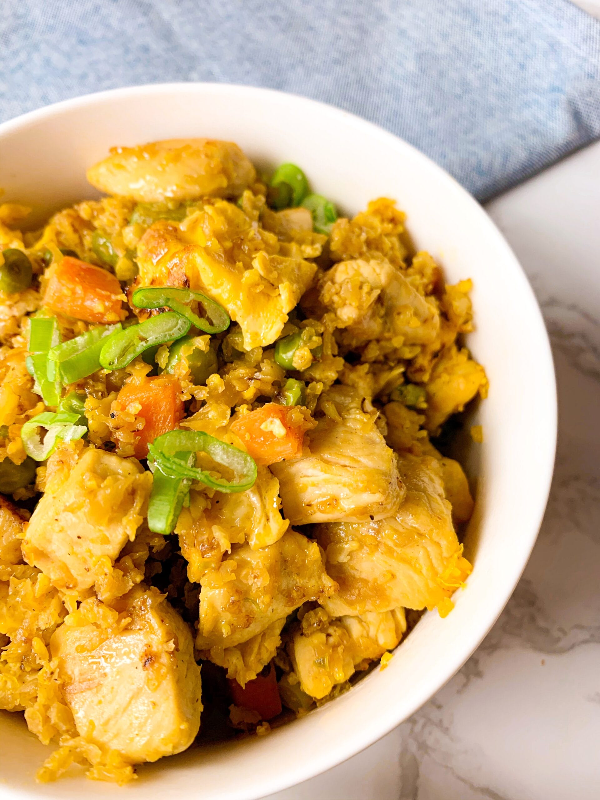Picture of a bowl of keto cauliflower fried rice, chicken and veggies