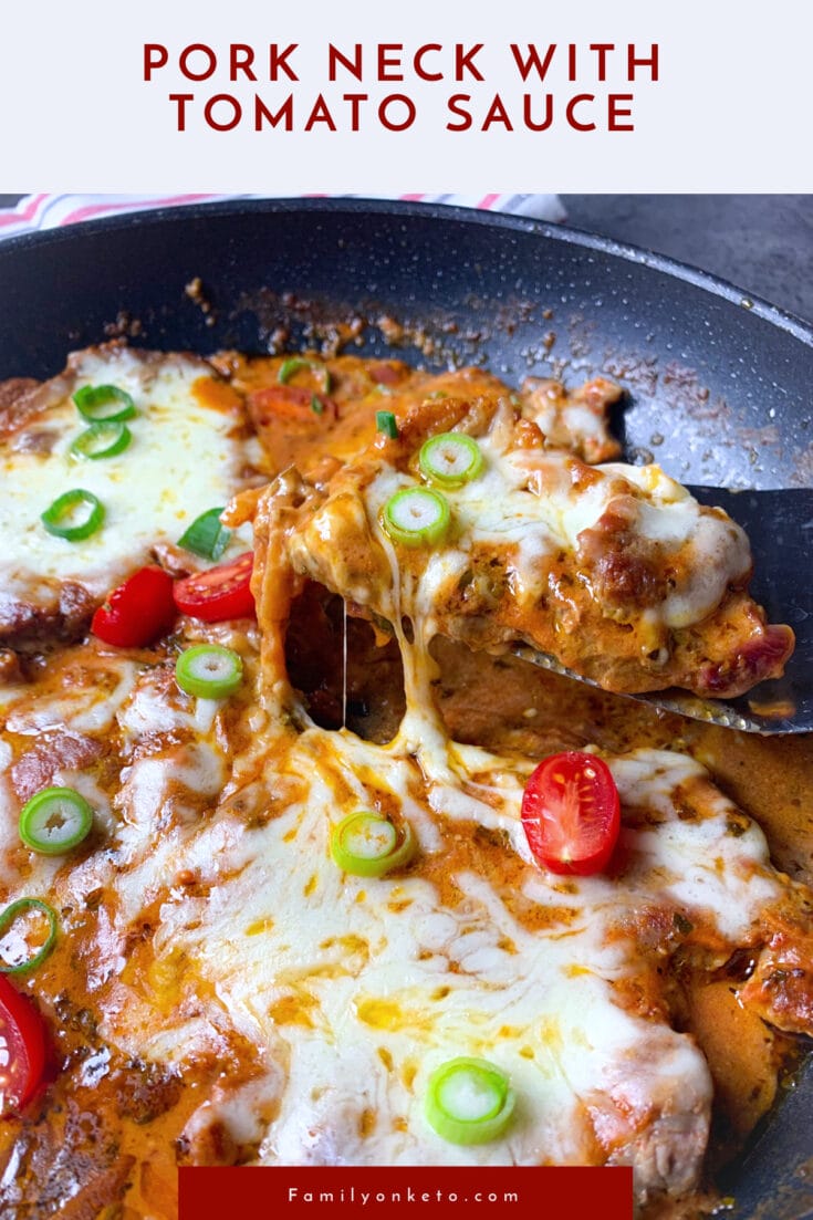 Pork neck with tomato sauce and melted mozzarella in a skillet
