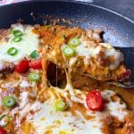 Pork neck steak with tomato sauce with melted mozzarella cooked in skillet