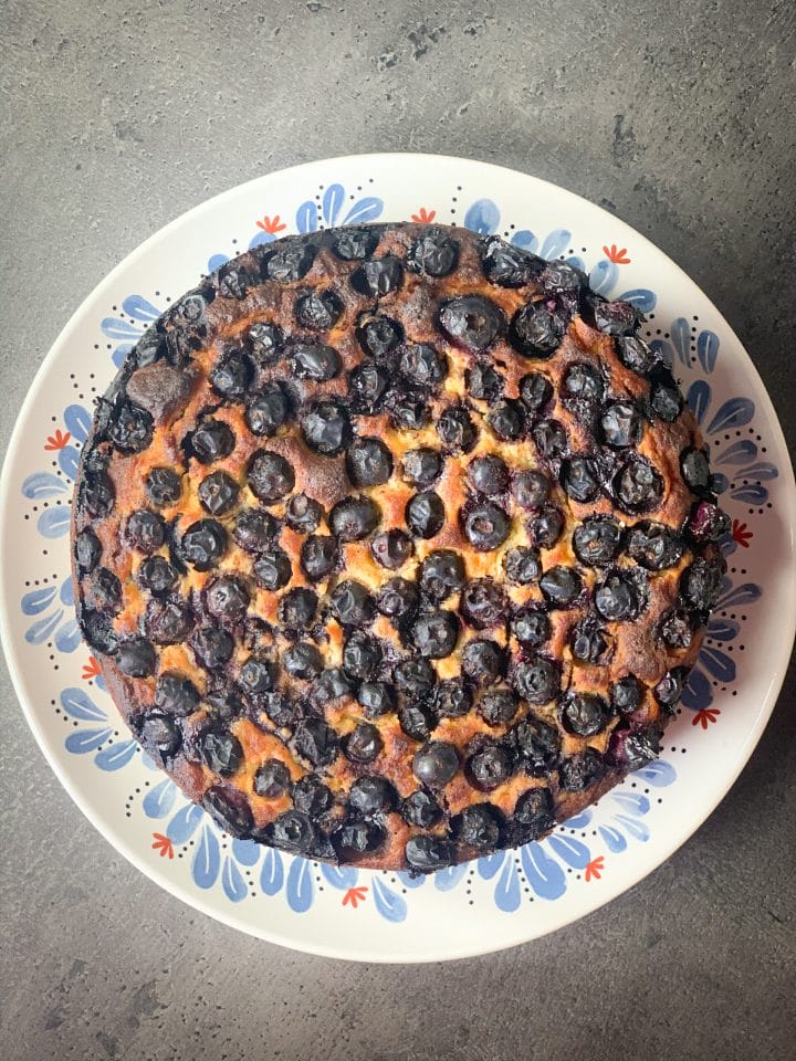 Picture of a whole keto blueberry pie on a plate