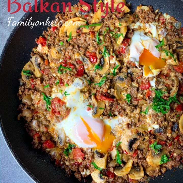 Ground beef hash in Balkan style with peppers, feta cheese and eggs in one skillet.