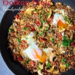 Ground beef hash in Balkan style with peppers, feta cheese and eggs in one skillet.