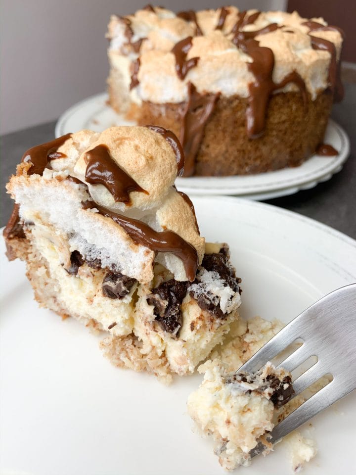 Picture of slice of low carb meringue cheesecake with chocolate that looks like S'mores cheesecake