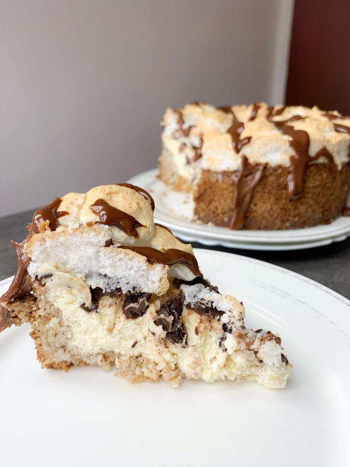 Photo of a slice of keto S'mores cheesecake pie with meringue topping