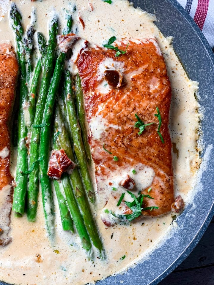 Picture of low carb salmon with creamy Tuscan sauce with garlic and butter and asparagus