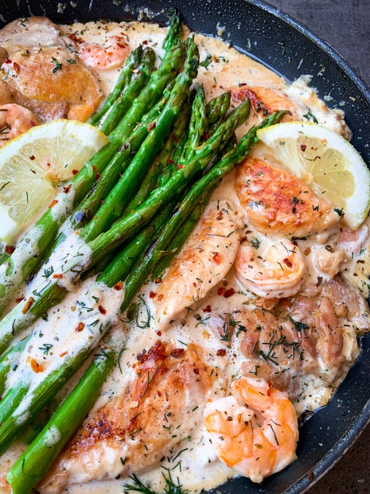 Picture of chicken with lemon cream sauce, shrimps, asparagus and dill