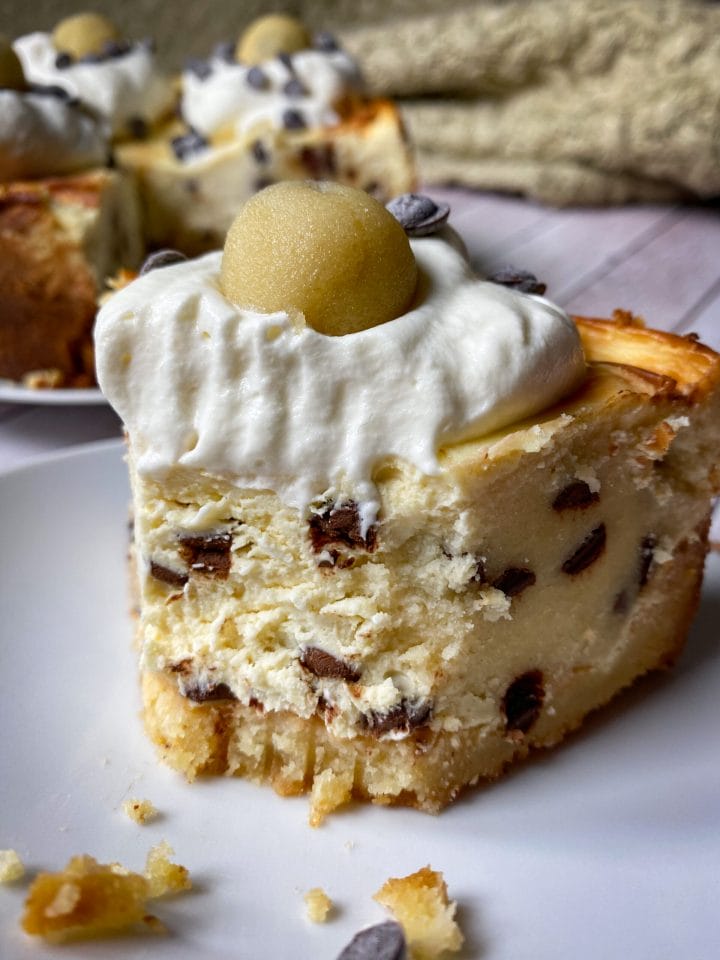 Picture of a slice of keto cheesecake with edible keto cookie dough