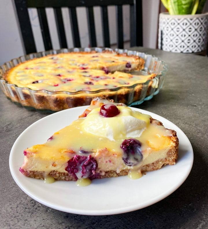 Picture of a sweet keto pie with cherries and silky vanilla cheesecake cream 