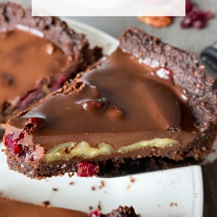Picture of keto chocolate ganache tart with pecan and dried cranberries