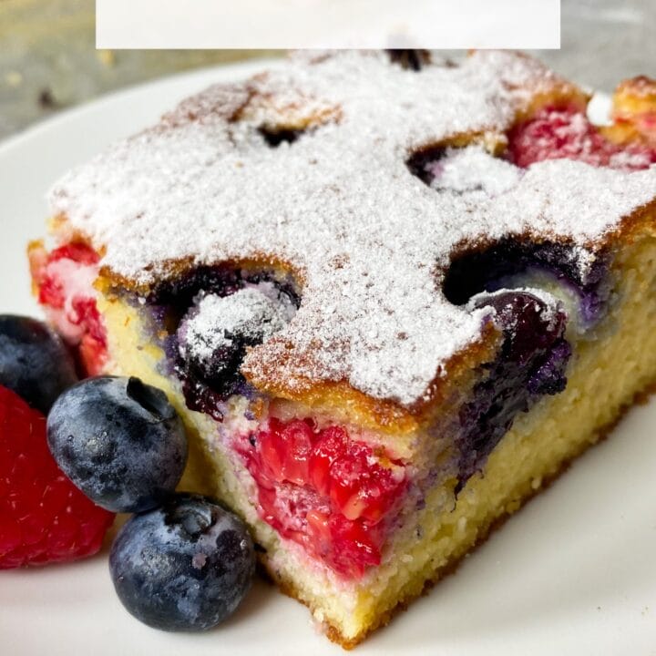 Picture of a slice of keto butter cake with berries on a plate
