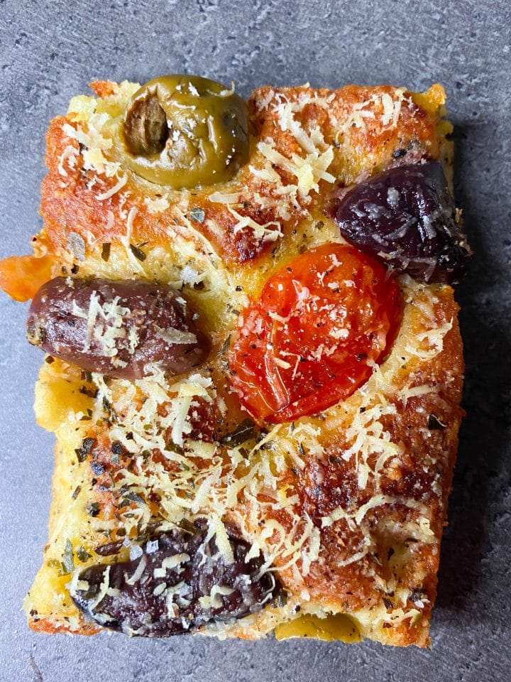 Picture of a slice of keto fathead focaccia with parmesan