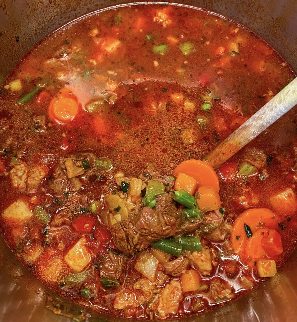 Photo of a Dutch oven full of minestrone soup with beef