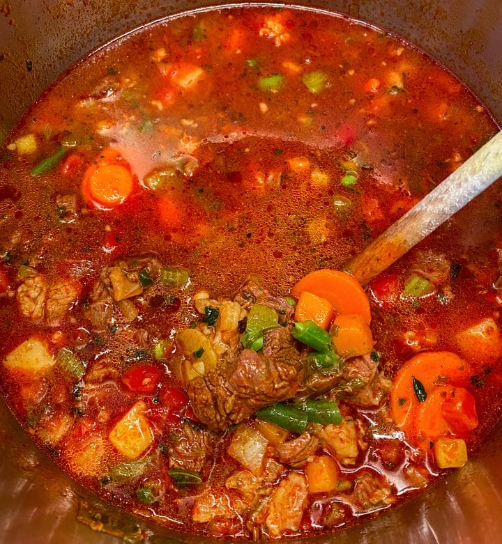 Photo of a Dutch oven full of minestrone soup with beef
