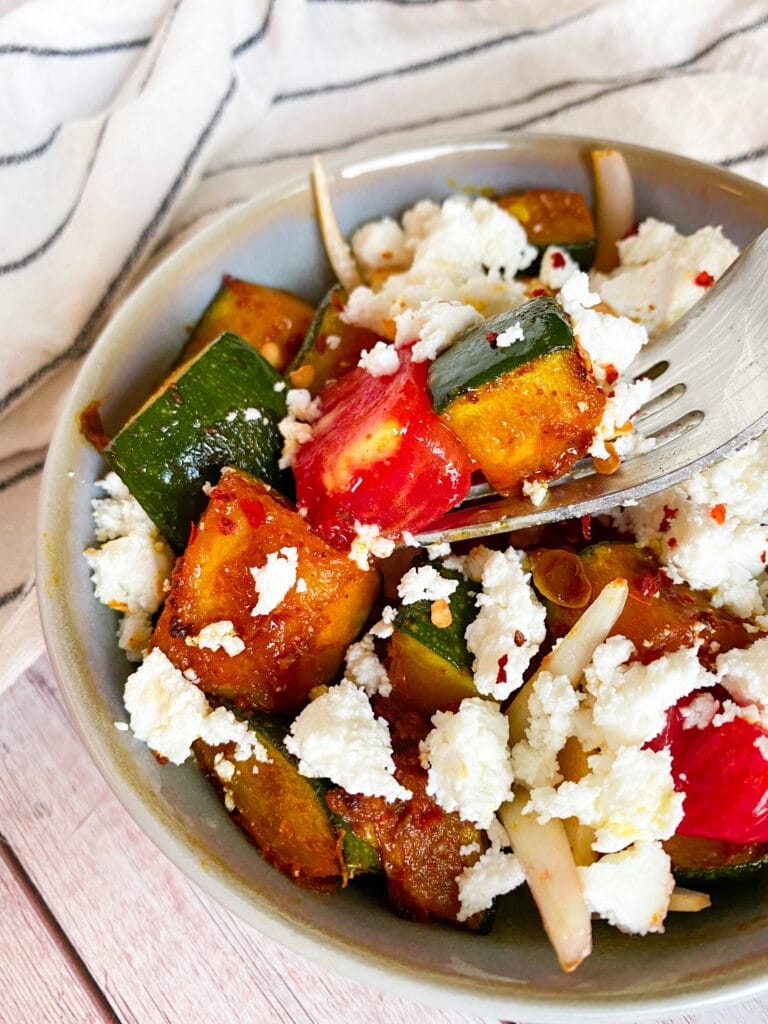 Picture of low carb zucchini salad with feta cheese, tomato and onion