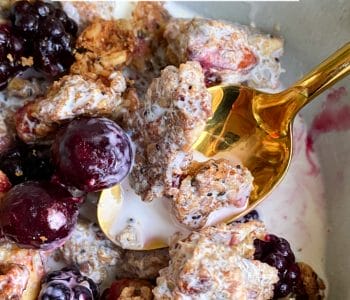 Picture of keto peanut butter granola in a bowl with berries and cream