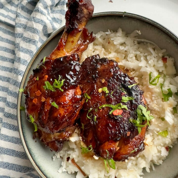 Picture of a bowl of cauliflower rice with keto Vietnamese Coconut Caramel Chicken