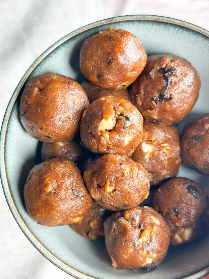 Photo showing a bowl full of keto chunky monkey energy balls. They look shiny and tasty!