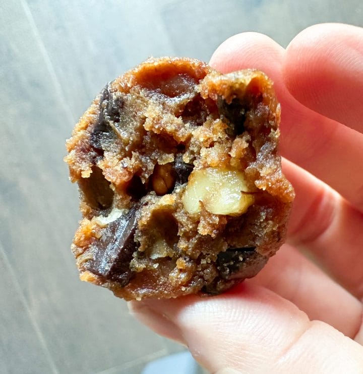 Picture of keto protein energy ball made of walnuts, peanut butter and chocolate chunks, called keto chunky monkey energy balls.
