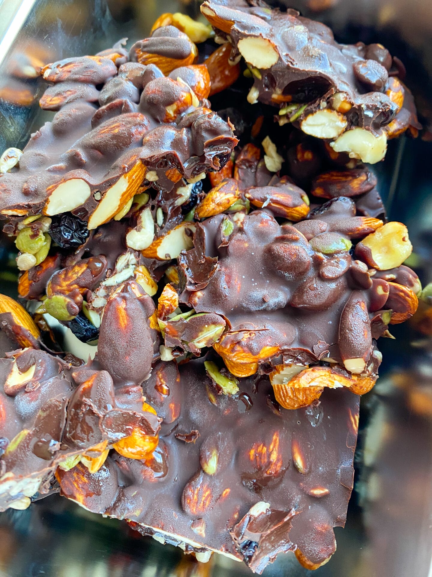 Picture of a metal container with keto frozen energy nut chocolate barks prepared for your post workout energy keto snack