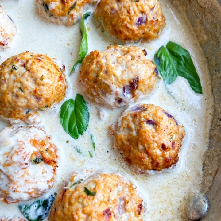 Picture of a skillet with Mediterranean turkey meatballs with sun-dried tomatoes in a rich keto Mediterranean sauce.